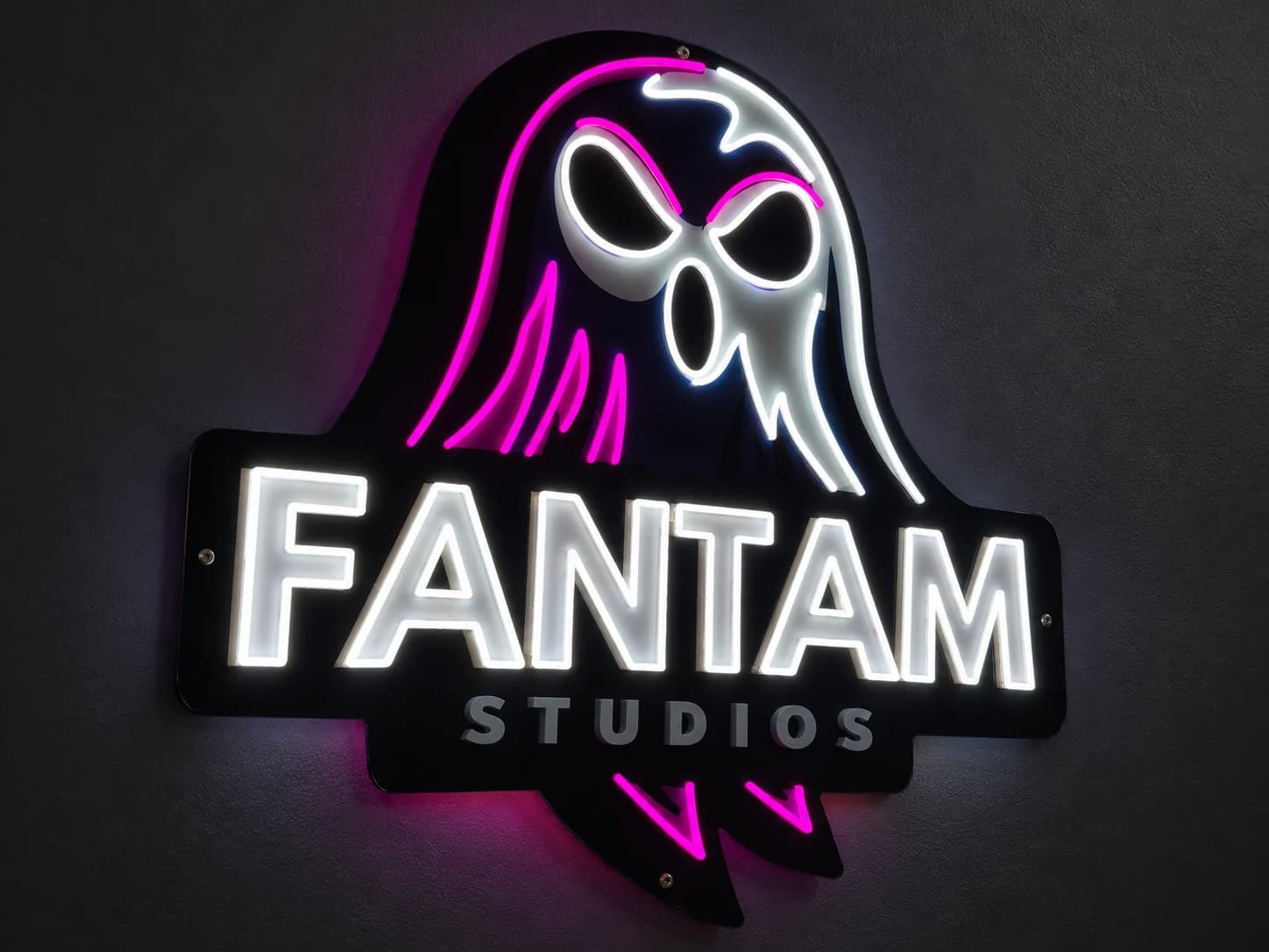 Custom FANTAM STUDIOS LED neon sign with a white ghost and magenta accents